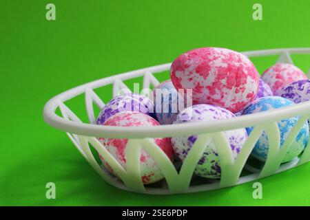 Colorful Easter Eggs with Spots in Plastic Basket Stock Photo