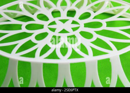 Mandala formed at the base of a plastic basket Stock Photo