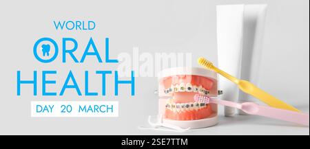 Model of jaw with braces, floss toothpicks, brushes and paste on light background. Banner for World Oral Health Day Stock Photo