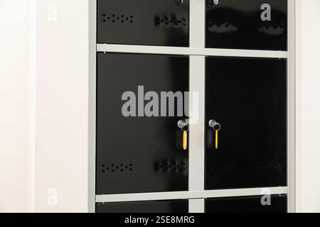 Modern lockers with bright keys indoors, closeup Stock Photo
