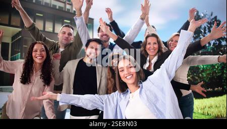 Excited diverse group of businesspeople celebrating professional success outdoors Stock Photo