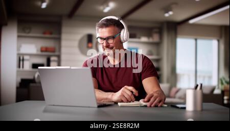 College Teacher At Home Using Laptop Computer Stock Photo