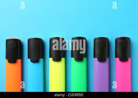 Bright highlighters on light blue background, flat lay Stock Photo