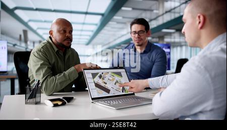 diverse group of real estate professionals collaborating on renovations. Stock Photo