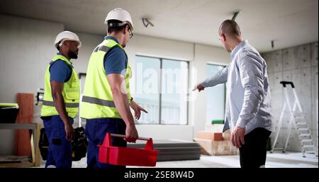Skilled workers renovate a new home, interior design improvements made. Stock Photo