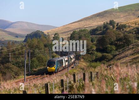 Avanti west coast Alstom pendolino train running through the scenic  Lune Gorge (south of Tebay, Cumbria) on the west coast mainline Stock Photo