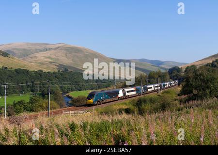 Avanti west coast Alstom pendolino train 390050 running through the scenic  Lune Gorge (south of Tebay, Cumbria) on the west coast mainline Stock Photo