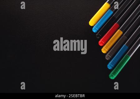 Multicolored markers for drawing on a black background Stock Photo