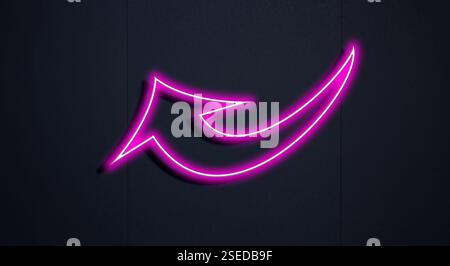 Pink neon arrow-shaped pointer on black wall Stock Photo