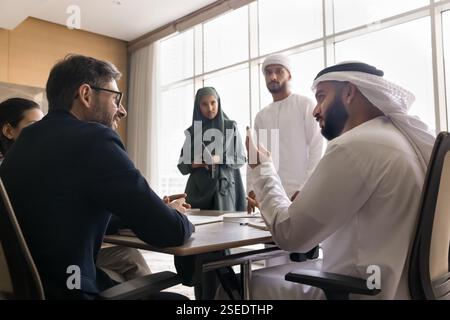 Multicultural businesspeople engaging in group meeting in office Stock Photo