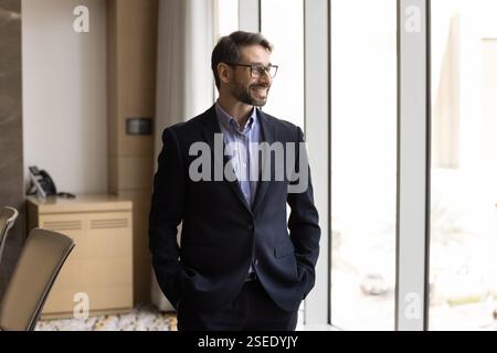 Pensive middle-aged Portuguese businessman professional posing in boardroom Stock Photo