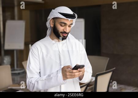 Young 25s Arabian business man using smartphone Stock Photo