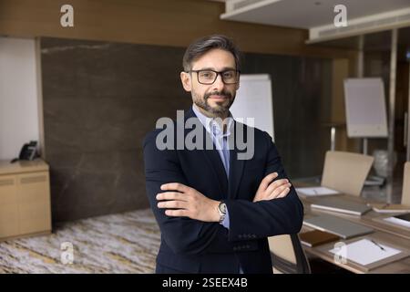 Mature 40s businessman in formal suit posing indoor Stock Photo