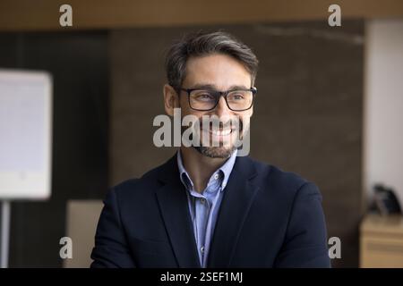 Handsome Portuguese middle-aged businessman posing in office Stock Photo