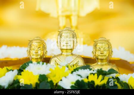 Portrait of three Golden boy Kumanthong top altar with flower. Kumanthong is be soul of a boy and superstition about spiritual in Thailand. Stock Photo
