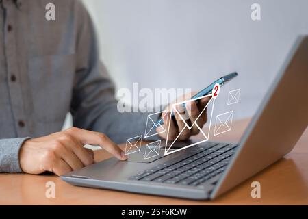 Man uses laptop with notification icon of two new email messages. Communication business technology. Stock Photo