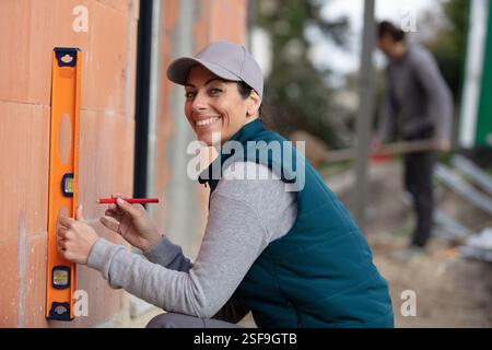 young woman using spirit level Stock Photo