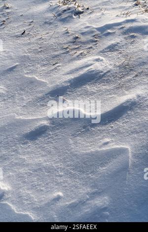 Shapes, textures, patterns created by snow and wind. Stock Photo