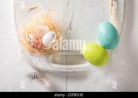 Creative Easter frame for a holiday card. Easter background made of Easter eggs and nest. Stock Photo