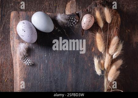 Closeup of Easter frame for a holiday card. Easter background made of Easter eggs and nest. Stock Photo