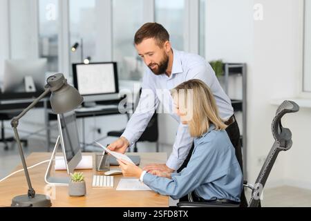 Technicians making digital engineering drawing on computer at desk in office Stock Photo