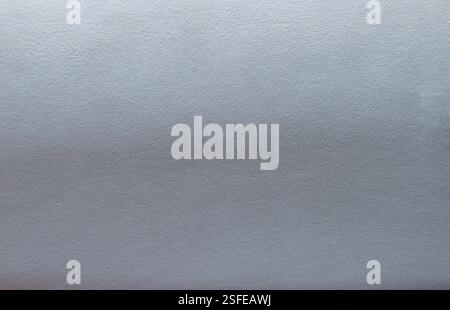 grey blue fabric velvet texture with lighter upper part and darker lower part, gradient from grey to blue with play of light on soft textile material Stock Photo