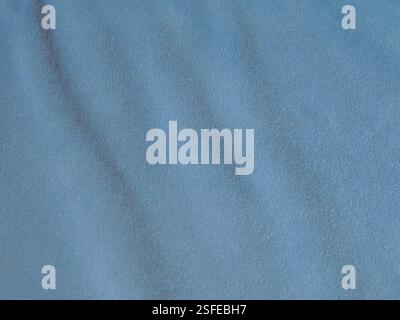 wavy velvet fabric soft blue color with soft texture as full frame canvas background, dense matte material with waves as drapery, graphic resource Stock Photo