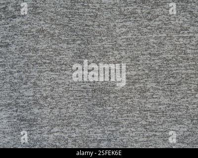 gray textile synthetic canvas with small ripples in texture close-up full frame, background of soft shiny dense material in gray tones Stock Photo