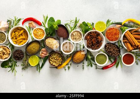 A collection of various spices and herbs on a gray background, perfect for enhancing dishes with flavors and textures Stock Photo