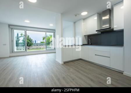 a newly fitted open kitchen leading to garden terrace in luxury mediterranean apartment real estate Stock Photo