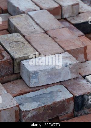 An isometric stack of various reclaimed house bricks Stock Photo