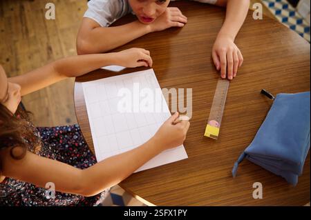 The Ruler Program Kids working on tasks together during recess after lesson in school ...