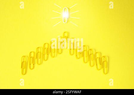 nnovation concept with paperclip,thinking,creativity,light bulb on yellow background,business and society concept. Stock Photo