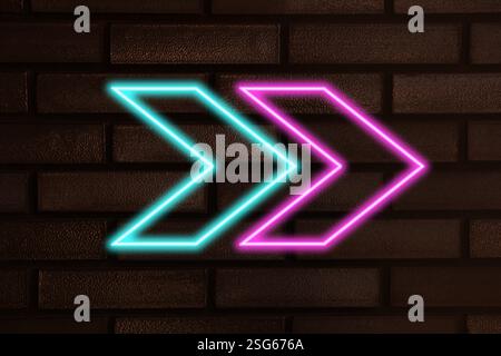 Bright neon arrow-shaped pointer on brick wall Stock Photo