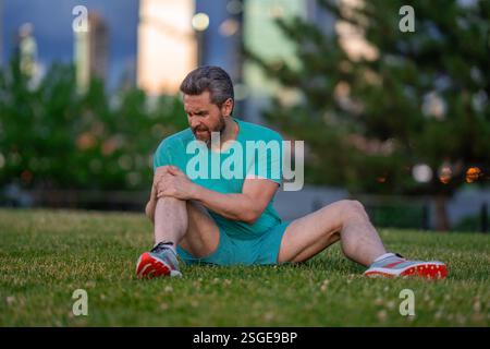 Knee after sport. Man struggling with leg pain. Injured man holding ...
