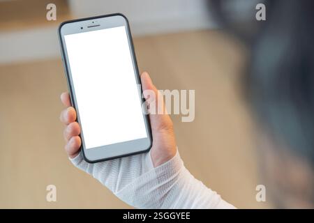 Back view of injured painful hand with bandage and using smart phone with isolate screen. Copy space, selective focus. Stock Photo