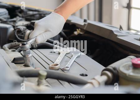 Hands of car mechanic in auto repair service. Auto mechanic working in garage. Repair service. Stock Photo