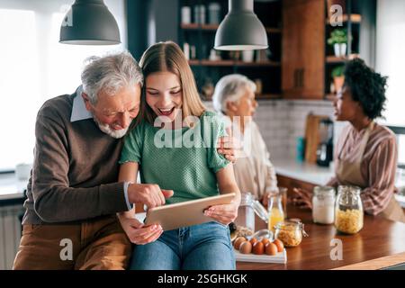 Portrait of happy multigeneration, multiethnic family having fun in kitchen at home Stock Photo