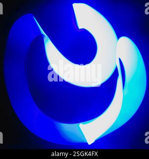 Abstract, experimental, long exposure picture of a blue light want being waved around at night, for textures, backgrounds, and artistic designs Stock Photo