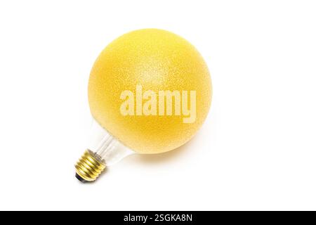 old incandescent lamp on white background, close-up. metal lamp base. isolated image of incandescent lamp. yellow lamp Stock Photo