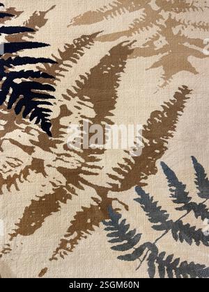 Close up of carpet rug with palm leaves pattern in shades of brown, beige, blue, white, and black color. Fabric or carpet in leaves foliage shape, sui Stock Photo