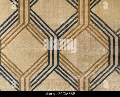 Close up of carpet rug fabric in weaving diamond pattern and lines. In brown, gold, and beige color. Seamless background texture. Stock Photo