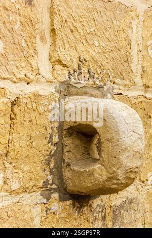 Detailed View of Ancient Stone Carving on a Weathered Wall Stock Photo