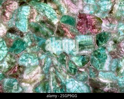 Close up of random cut mineral marble gem stone carved and joined together on a surface. In cyan, blue, green, tosca, and purple magenta color. Beauti Stock Photo