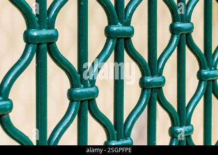 Close-Up View of a Decorative Green Metal Security Fence Patterned Design Stock Photo