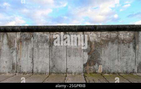 Part of Berlin Wall or Berliner Mauer with blue sky Stock Photo
