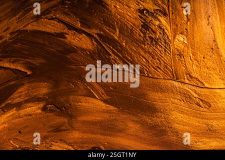 Background with yellow and gold paint texture applied with large strokes of a brush or spatula. High quality photo Stock Photo