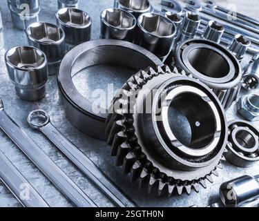 Close-up view of various metal tools and mechanical parts arranged on workbench at a workshop during afternoon Stock Photo