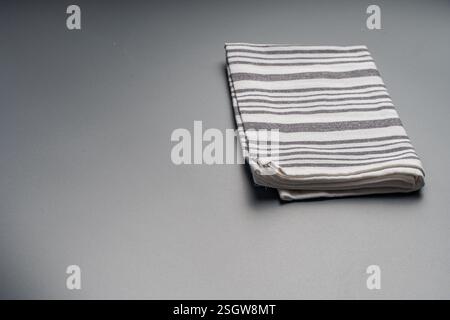 The towel is light gray with white stripes on a gray background. Space for text. High quality photo Stock Photo