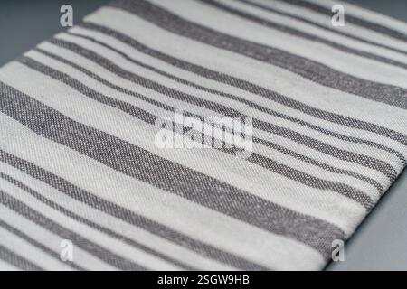 The towel is light gray with white stripes on a gray background. Space for text. High quality photo Stock Photo